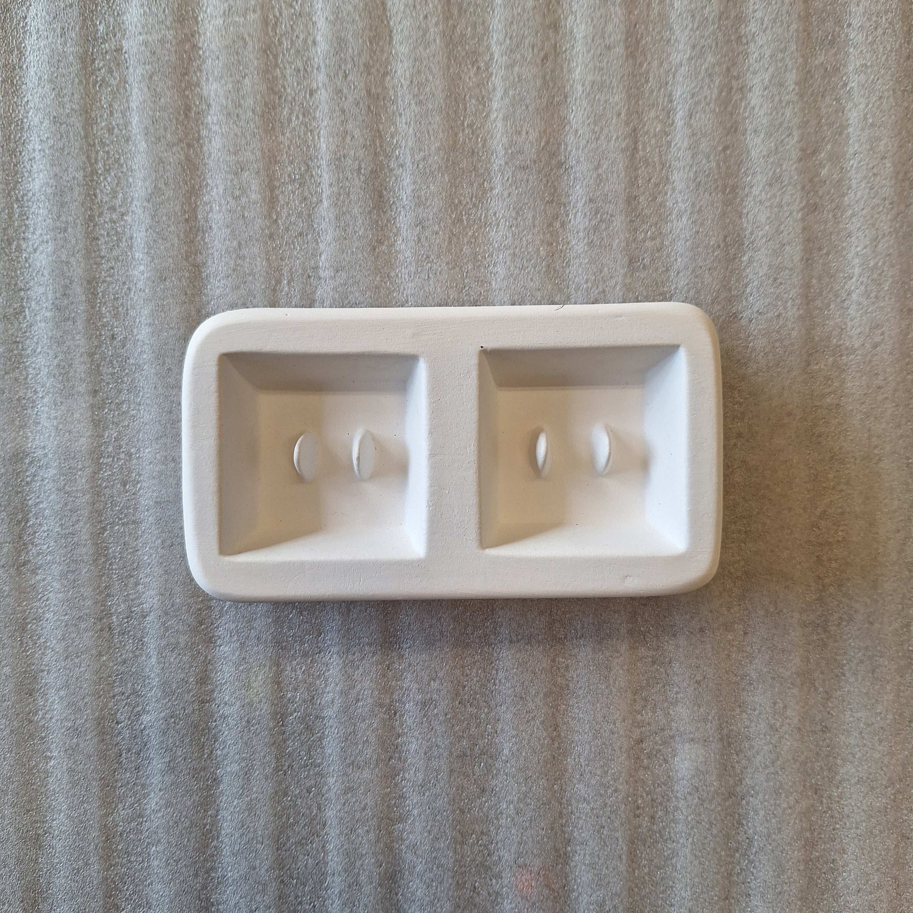 Two square button mold for glass casting.