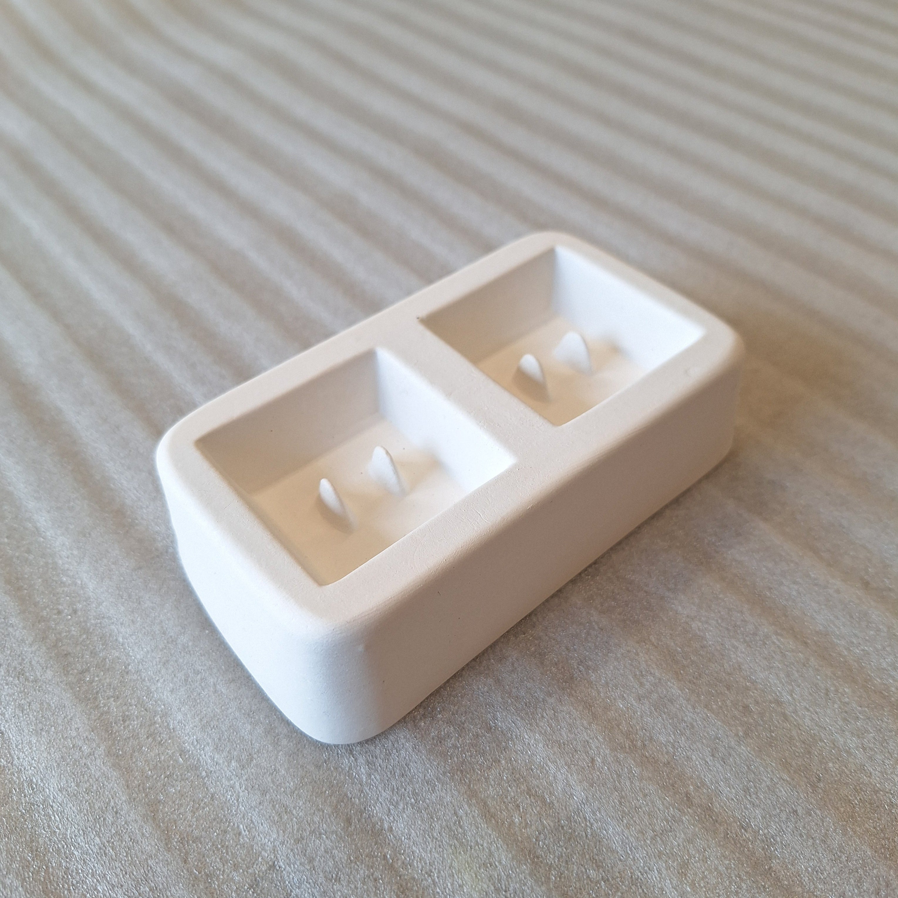 Two square button mold for glass casting.