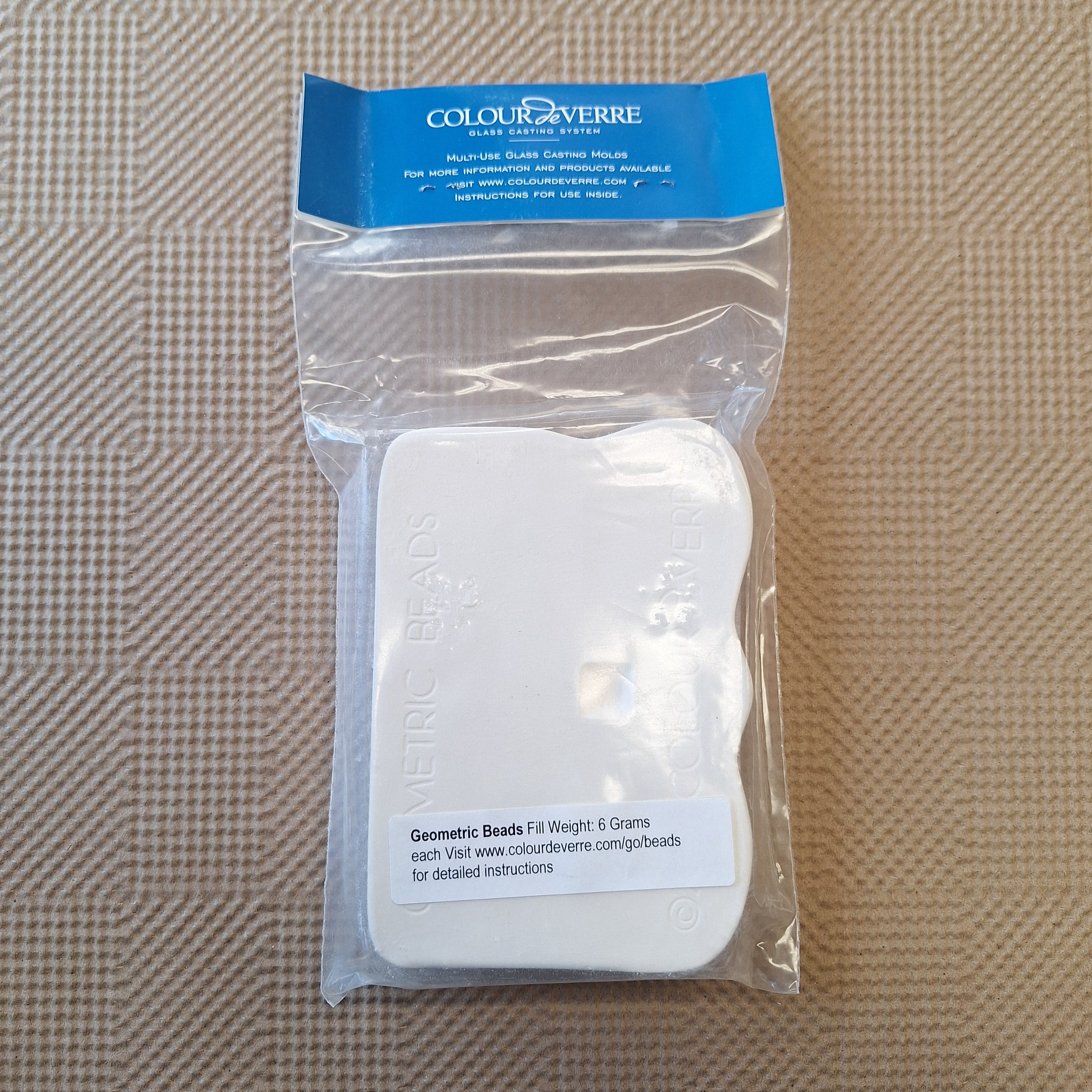 Packaged glass casting mold with 'Colour de Verre' branding on a textured brown background
