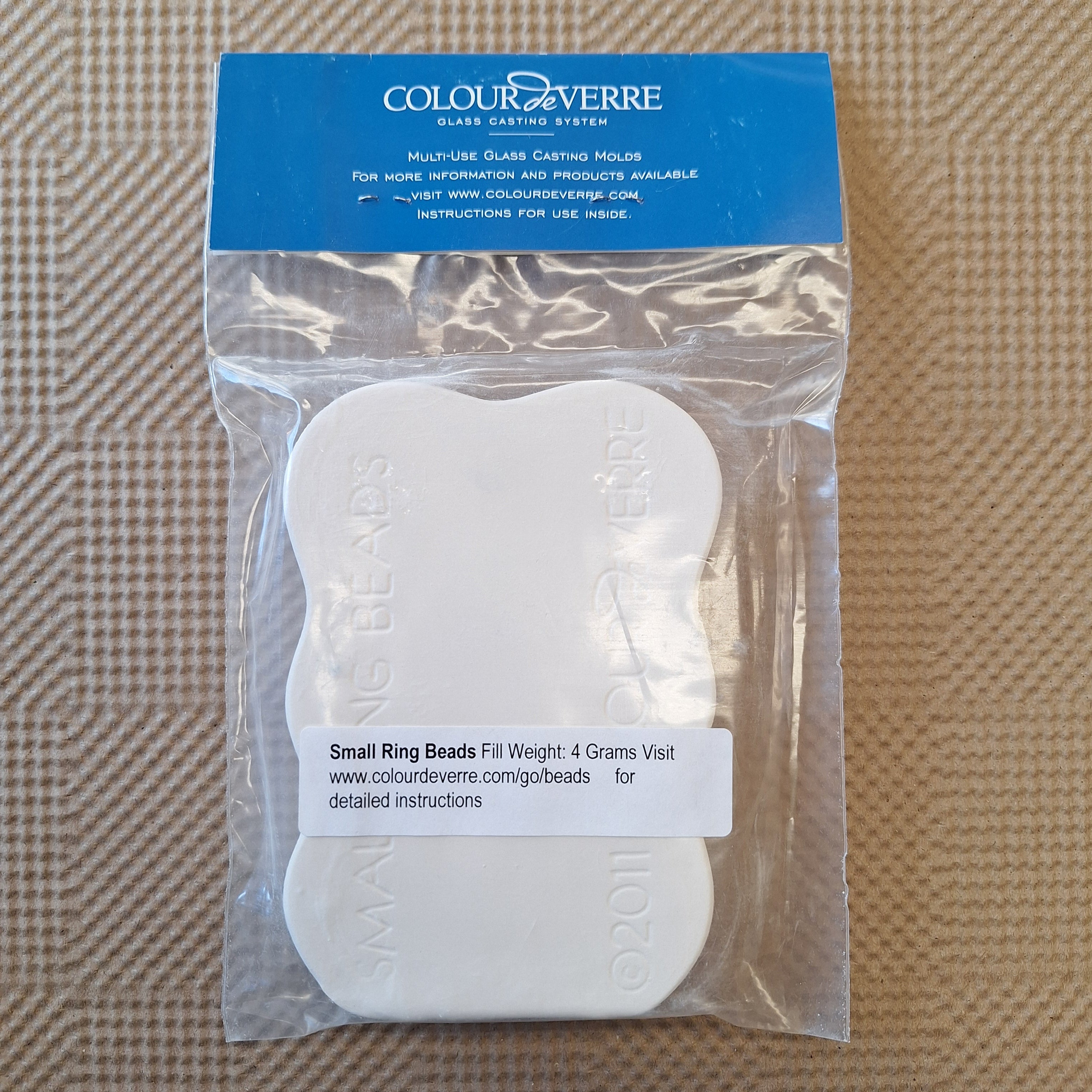 Packaged glass casting mold with 'Colour de Verre' branding on a textured brown background