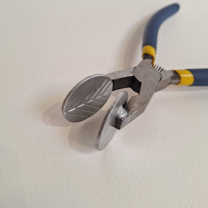 Pair of lampworking mashers with blue handles on a white background